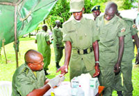Captain Dr. Lawrence Basaaliza takes blood samples from Presidential Guard Brigade soldiers in Entebbe yesterday